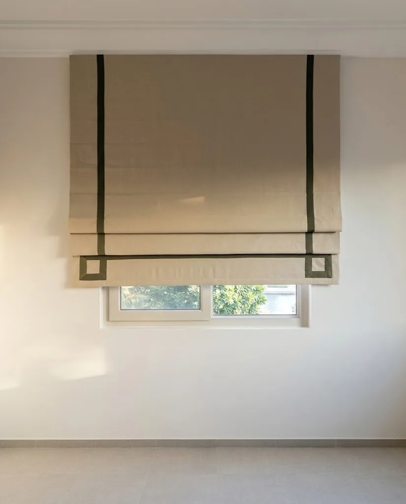 Close-up of a beige Roman blind with a black border