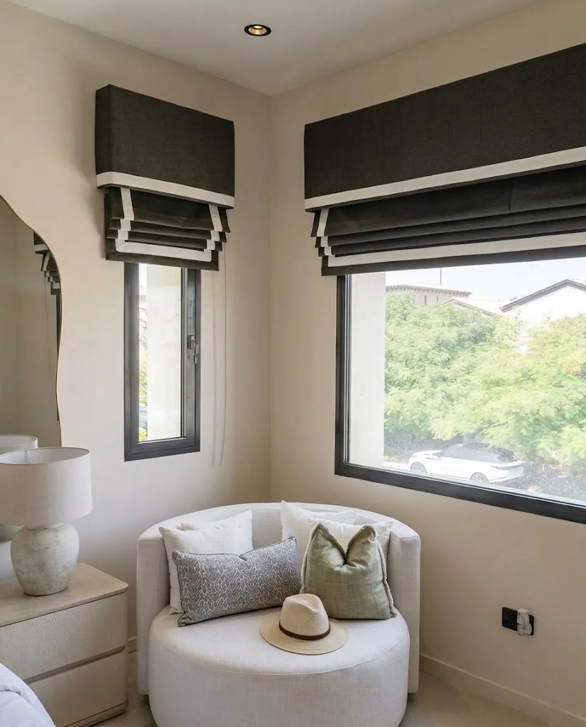 Black and cream Roman blinds in a reading nook