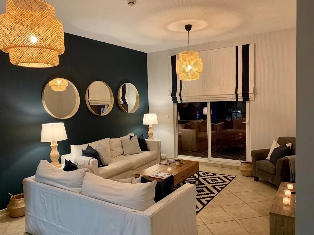 Striped Roman blinds in a living room with a navy wall