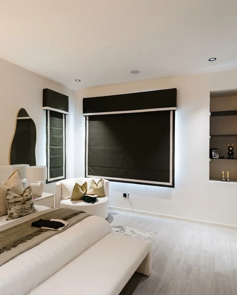 Black Roman blinds on bedroom windows