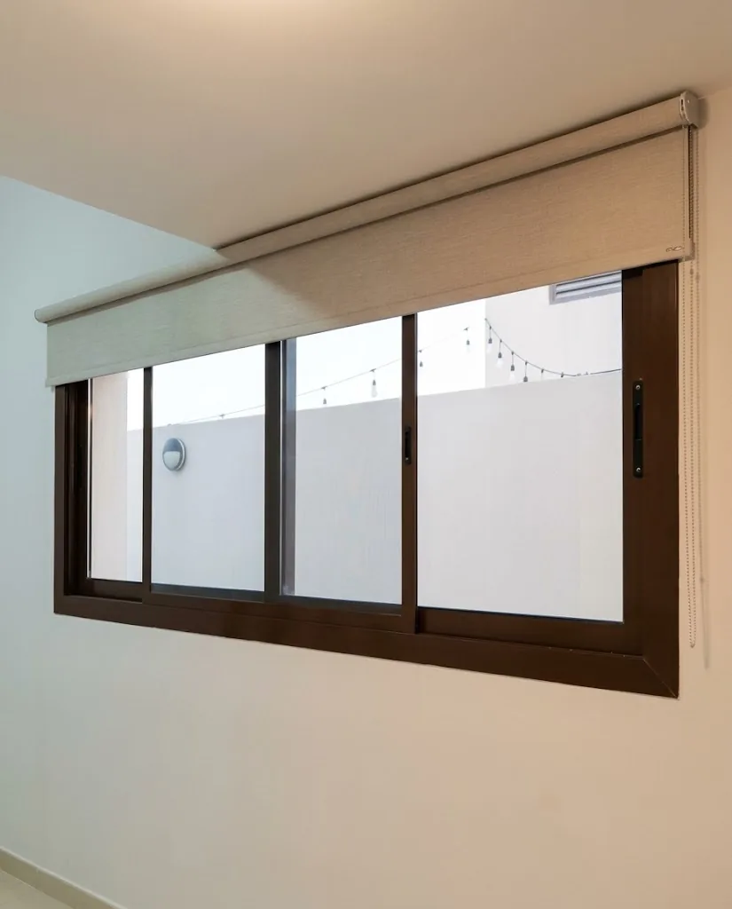 Cream roller blind on a wide window