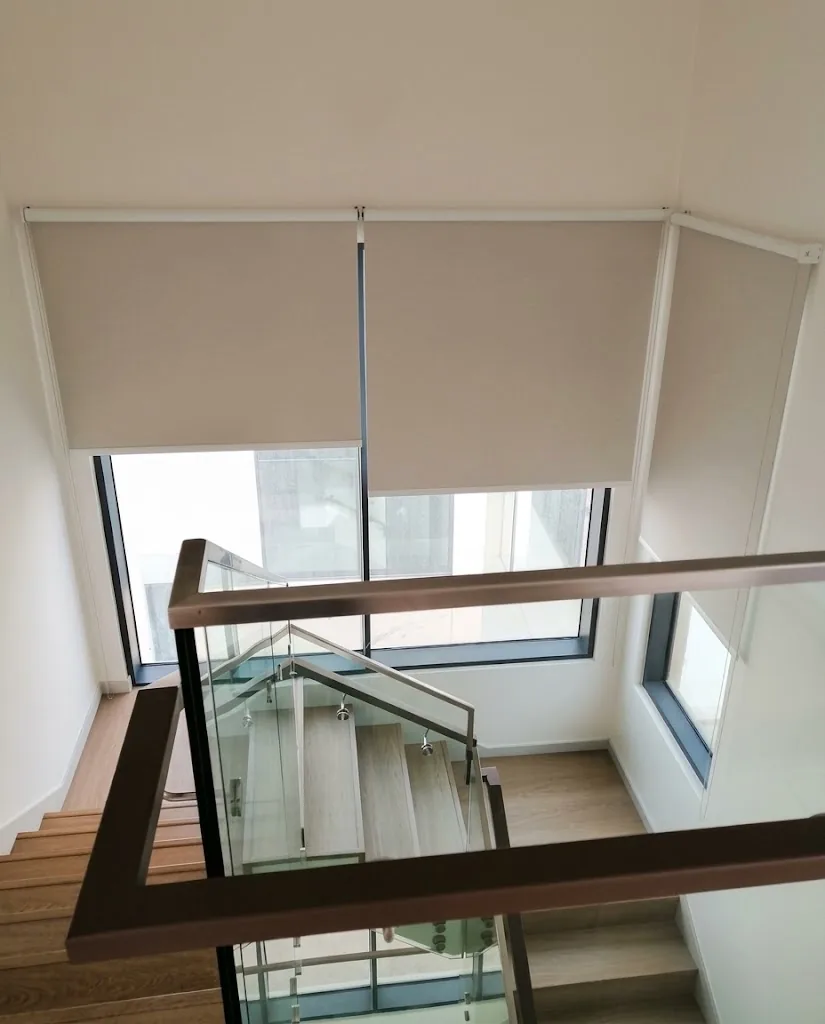 Beige roller blinds on stairwell windows