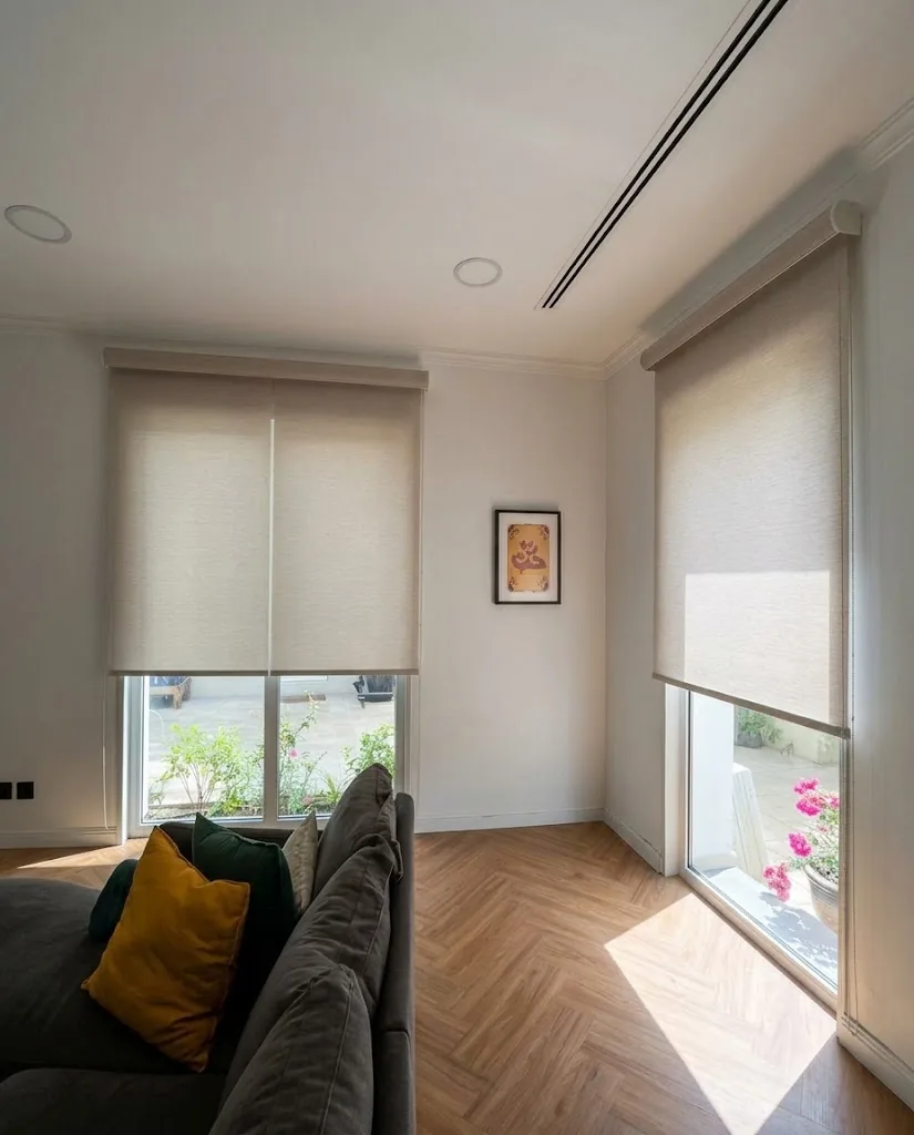 Sheer screen roller blinds in a living room