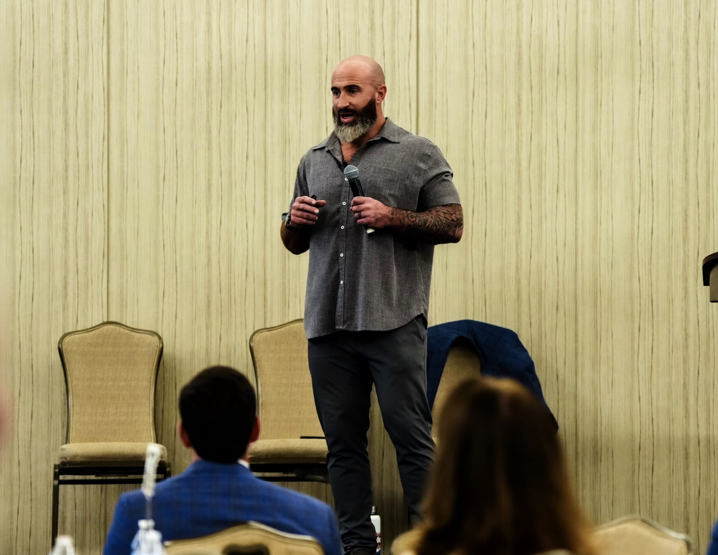 Kyle Newell speaking on stage