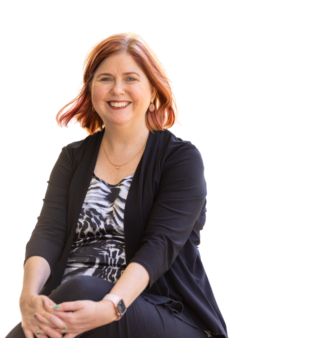 Sharon a woman with red hair wearing a black suit jacket and a zebra shirt. Australian physiotherapy of the year 2024, leader of an ehlers danlos society core network clinic, treating hypermobility for twenty plus years.