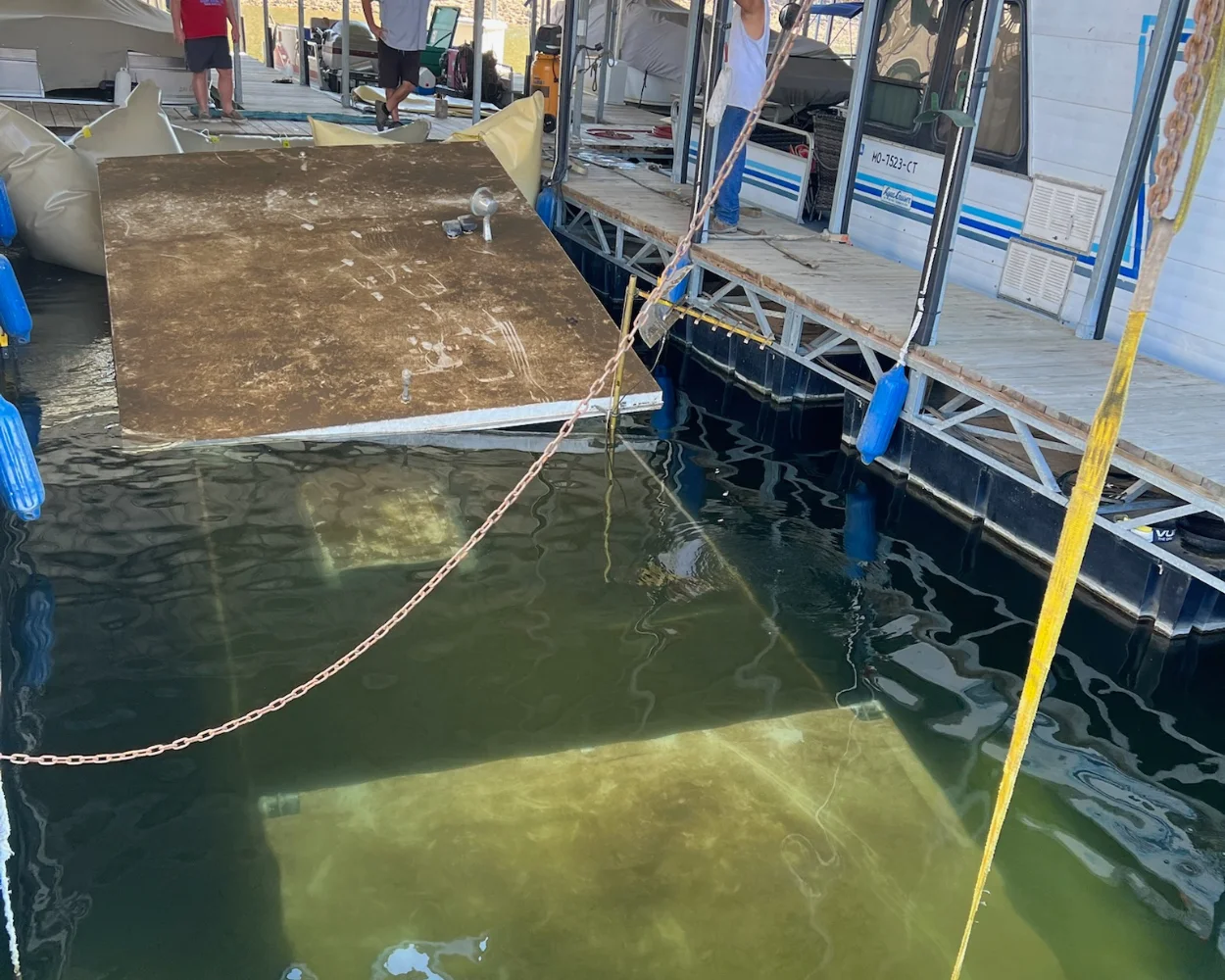 A house boat sunk in a dock slip