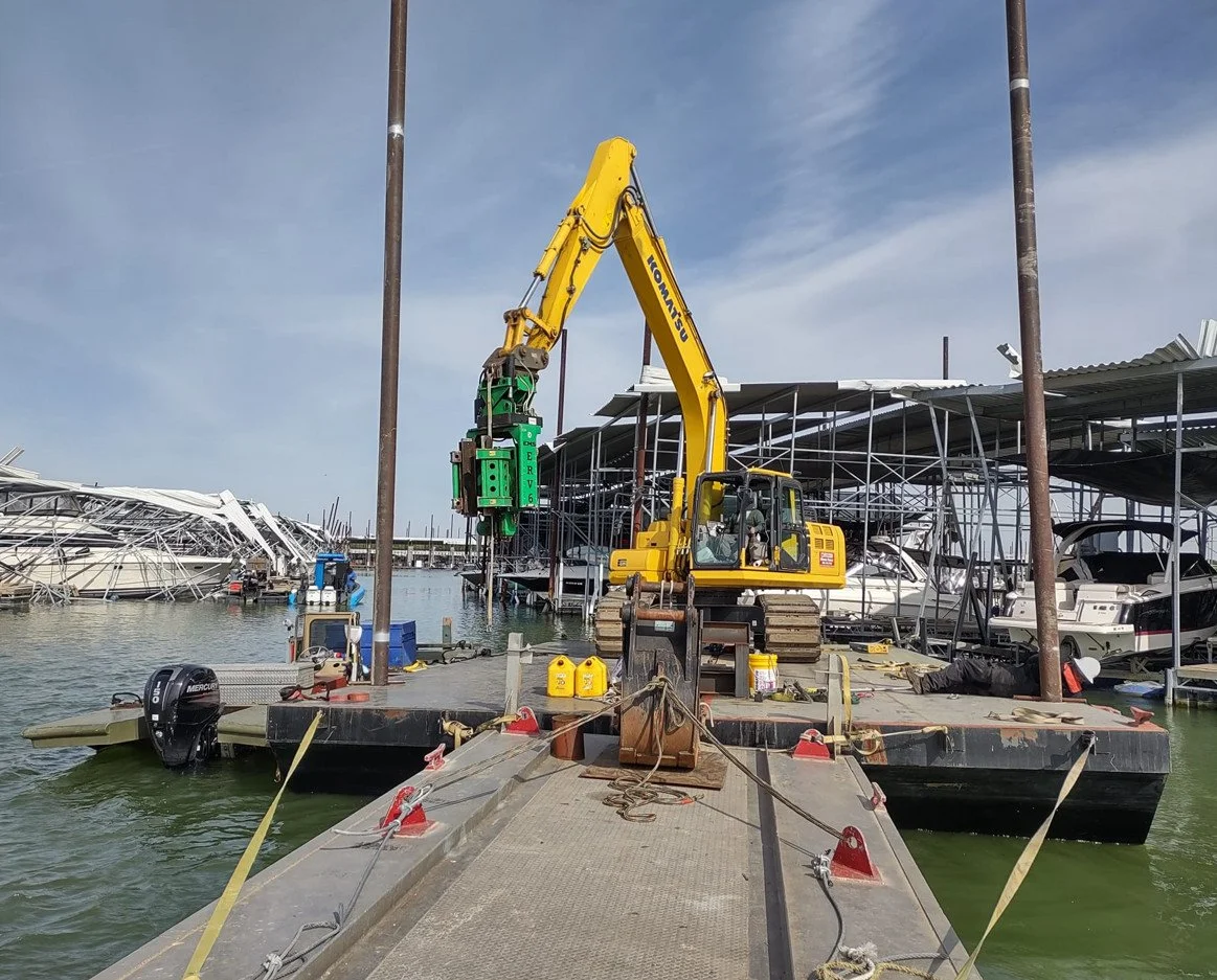 Excavator on a dock repairing storm damage