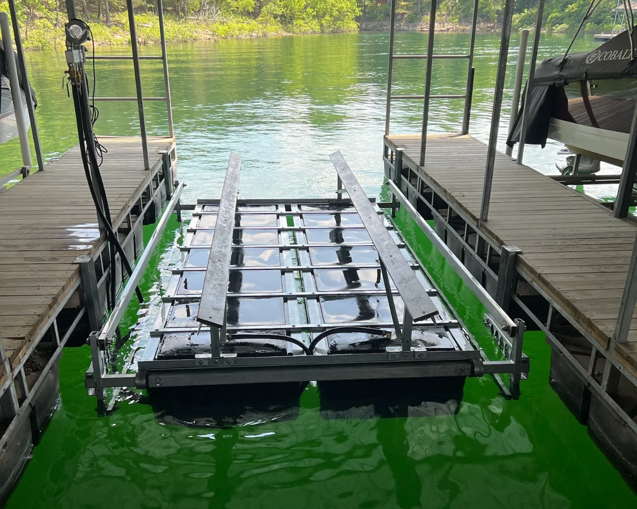 Boat lift in green lake water