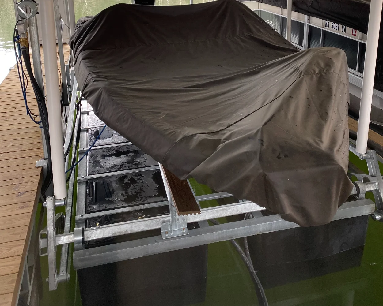 Boat lift with a covered boat on it