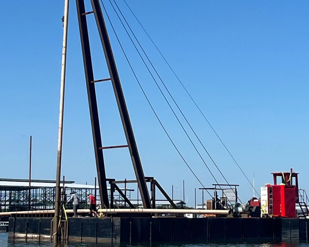 Barge crew pile driving