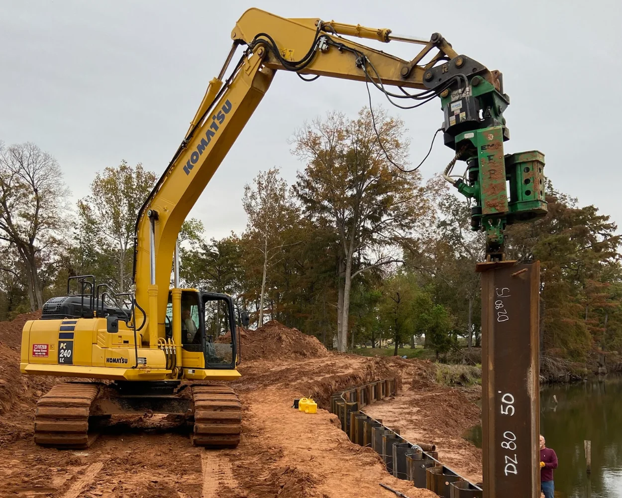 Excavator driving in a sea wall