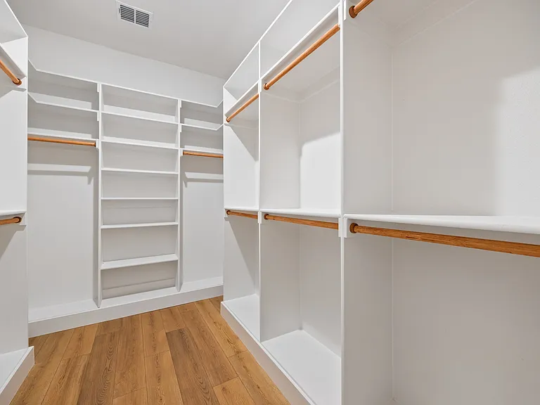 Residential closet with shelving drawers and organized hanging space