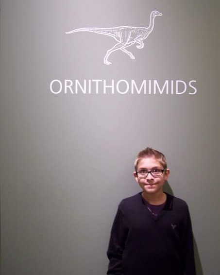 A young Evan Jevnikar at a dinosaur museum exhibit.