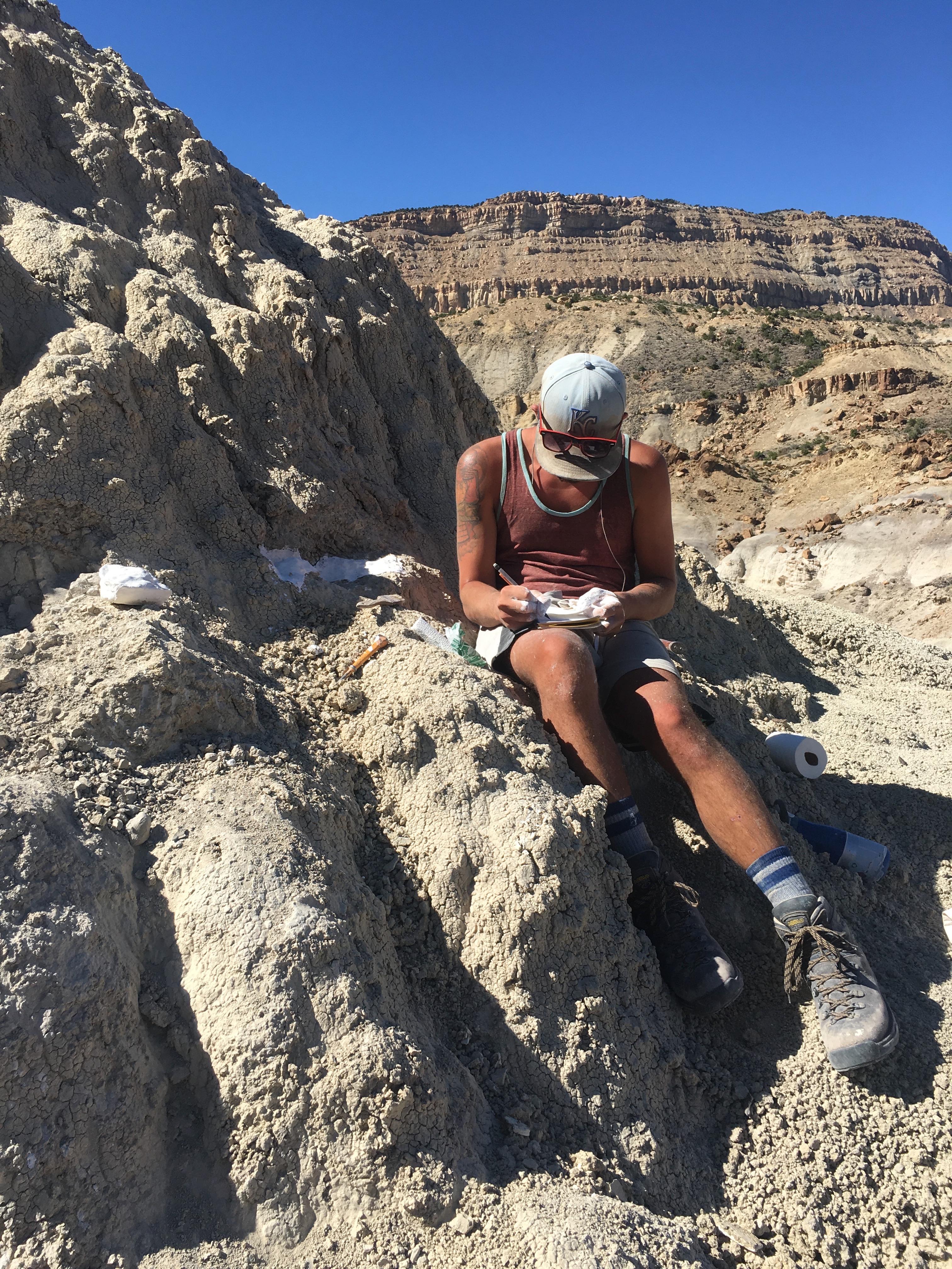 Field portrait, Evan Jevnikar at a Cretaceous-era dig site.