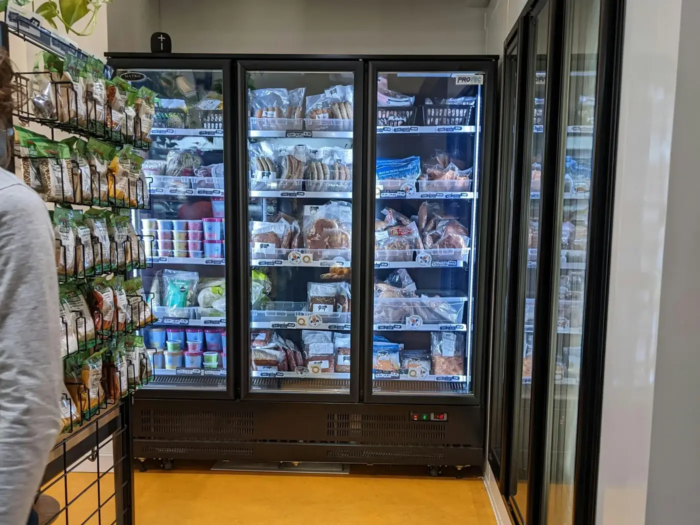 Row of glass-door reach-in freezers in a store