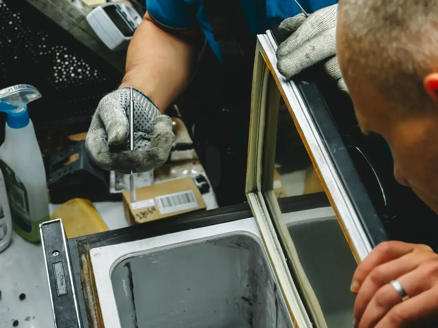 Technicians repairing a commercial freezer