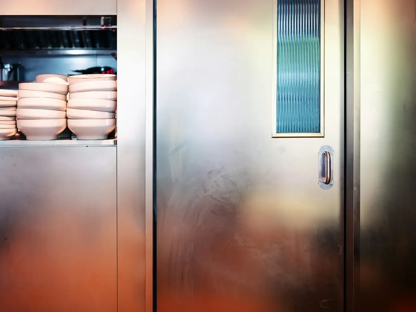 Stainless steel walk-in cooler door in a commercial kitchen