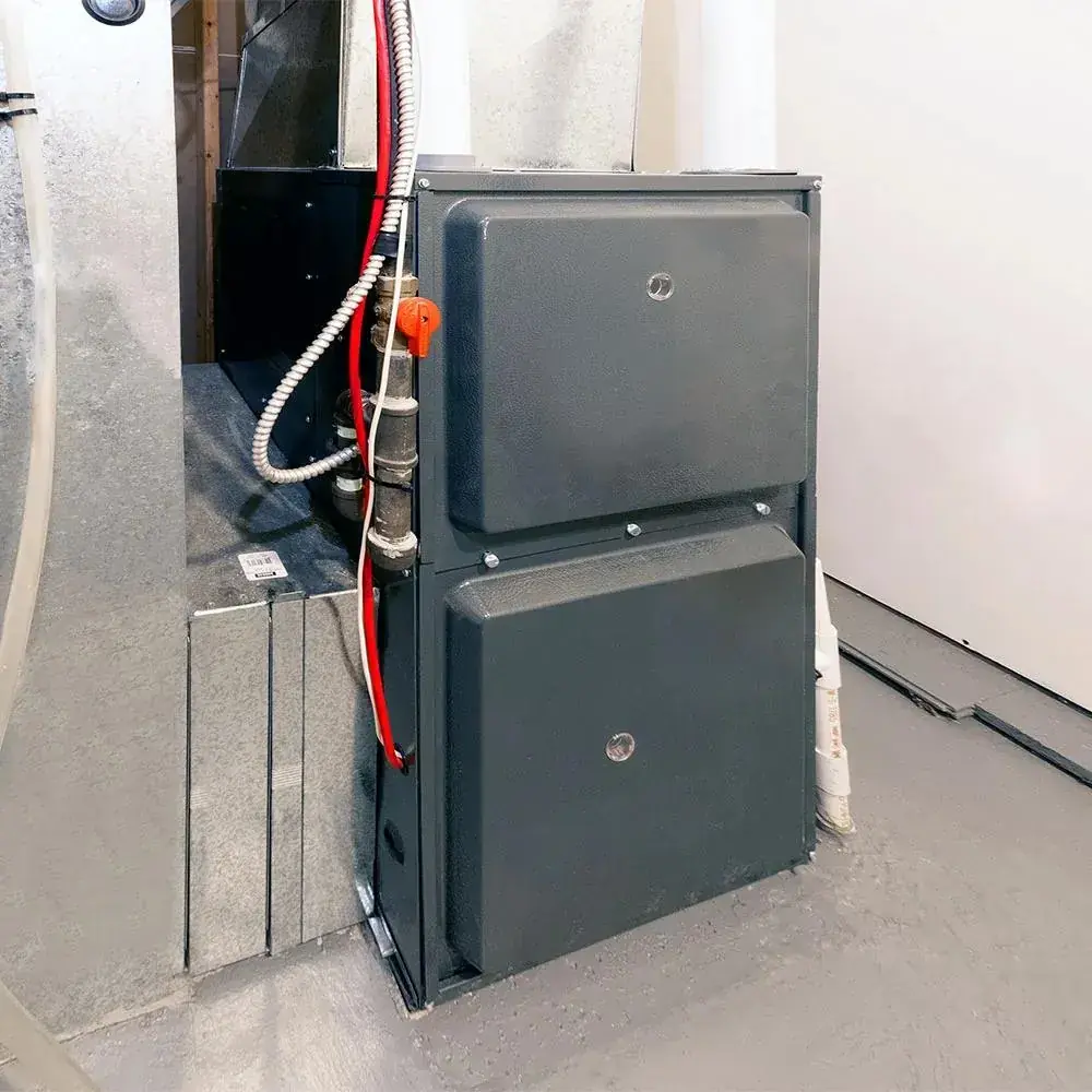 Clean indoor air handler installation with ductwork and copper lines