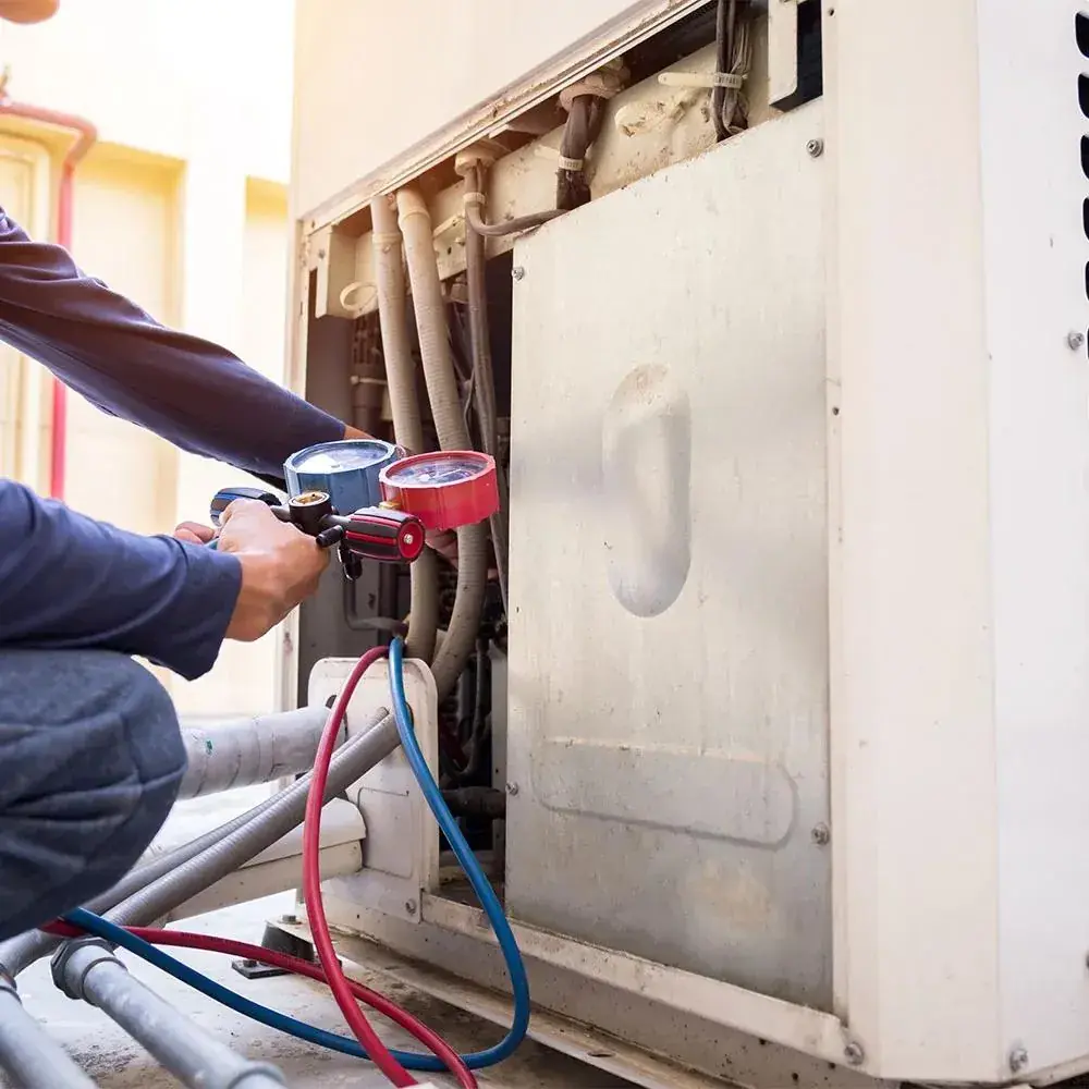 Gauge set connected to an outdoor AC unit during a service check