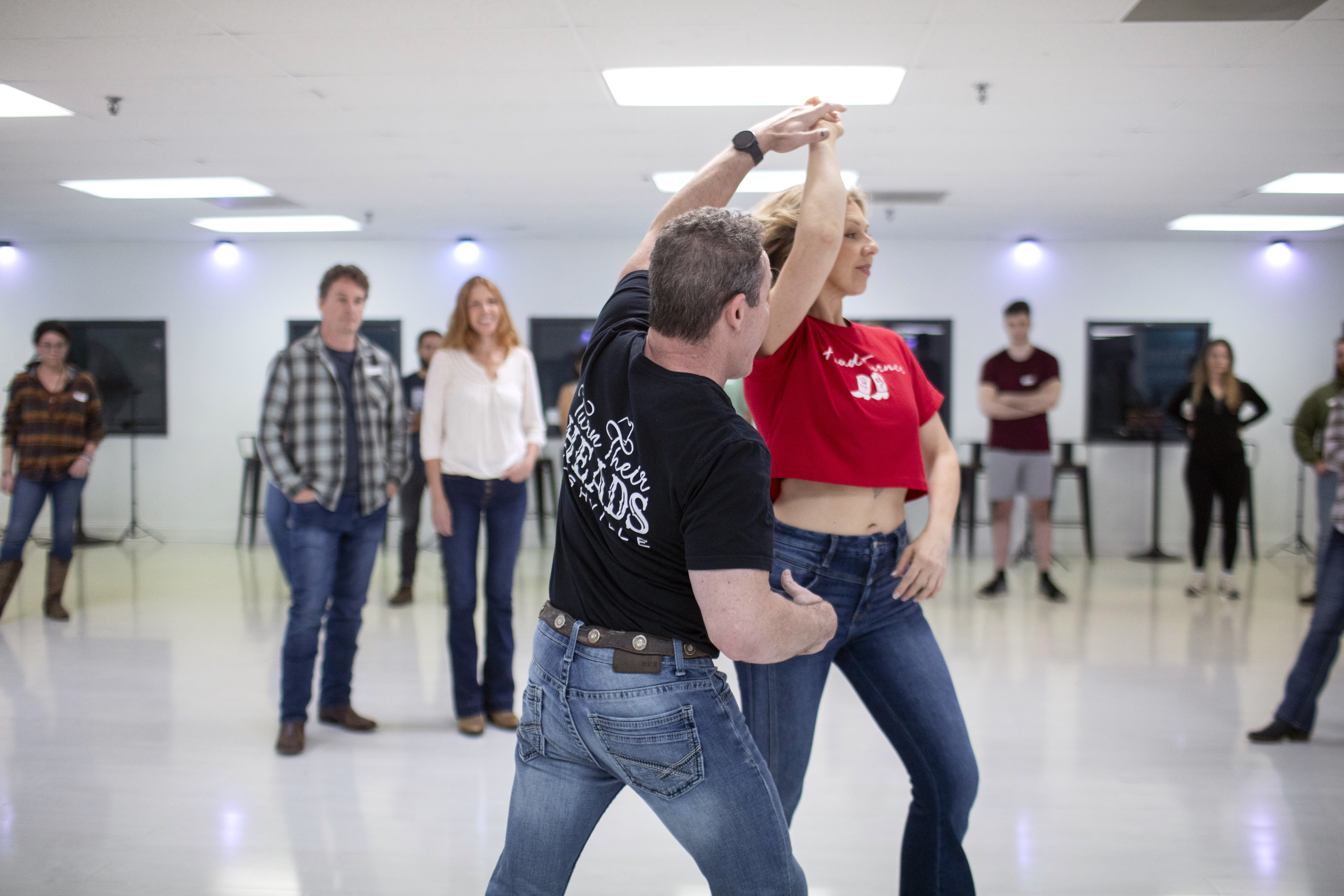 An instructor guiding a Country Swing turn during a studio lesson