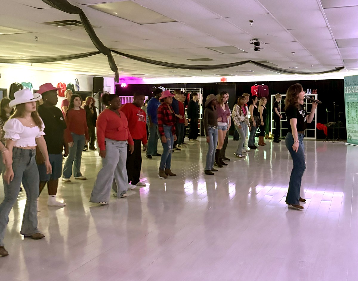Students following an instructor during a private line dance lesson.