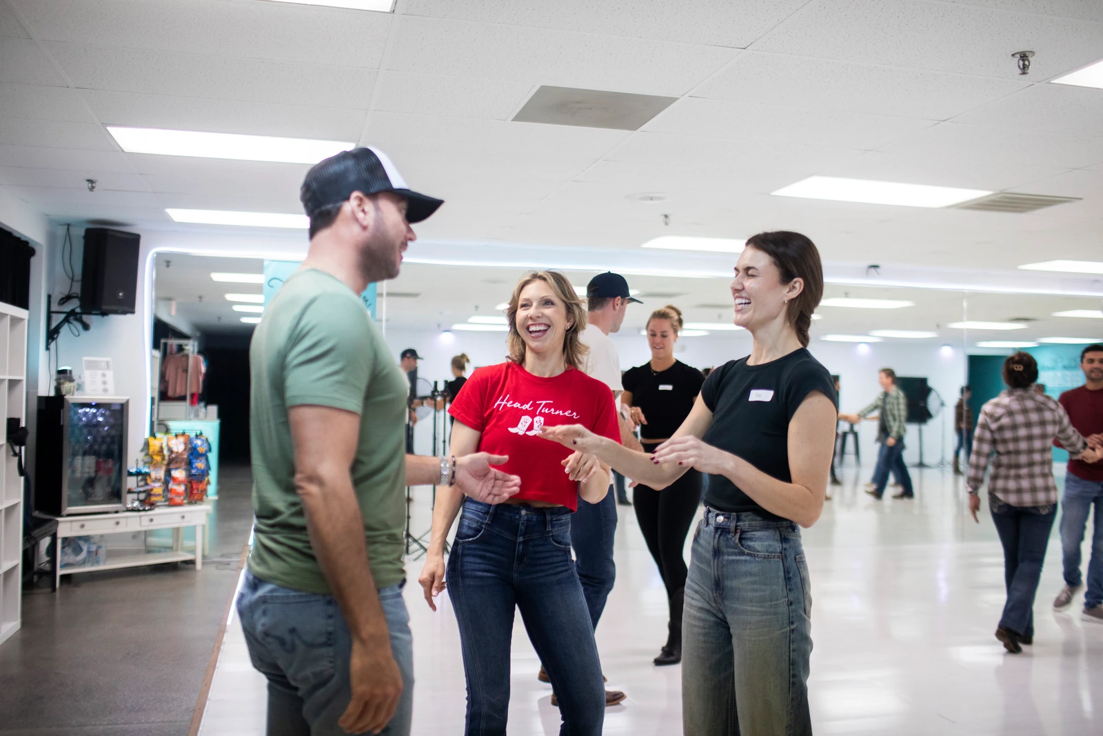 A couple learning Country Swing with an instructor at Turn Their Heads
