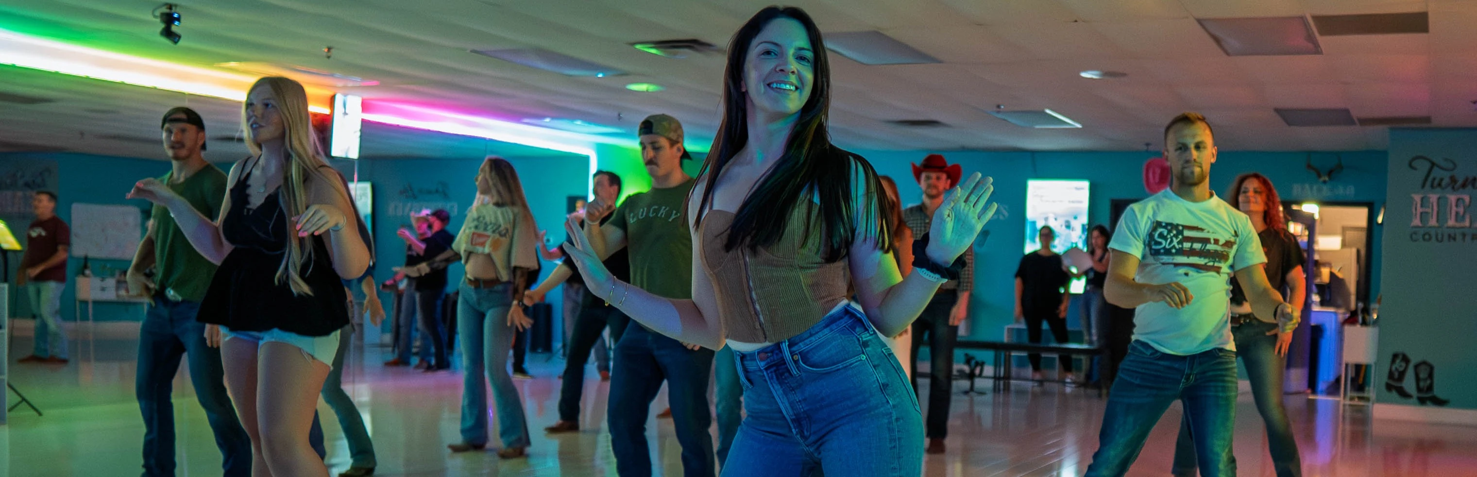 Guests learning to line dance at Turn Their Heads