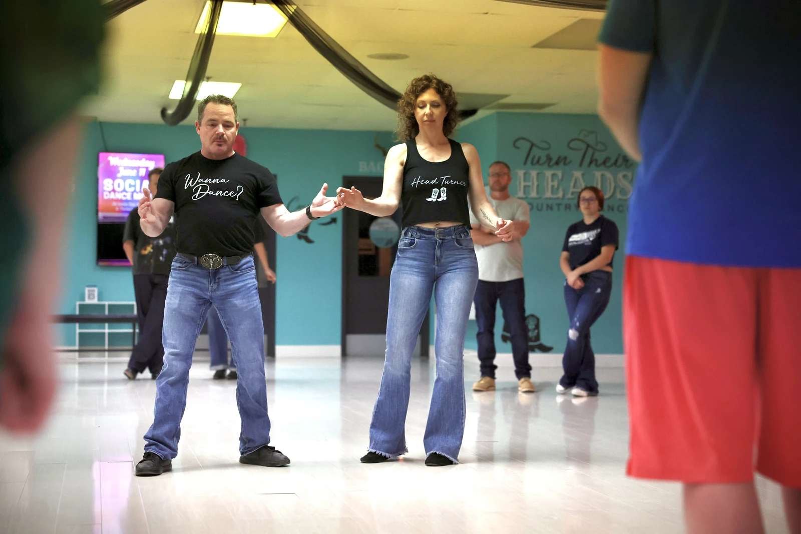 Instructors teaching Country Swing connection in a public class