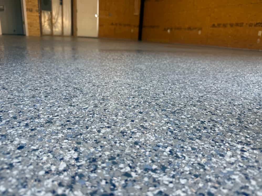 Concrete overlay resurfacing a worn slab with a smooth tan finish