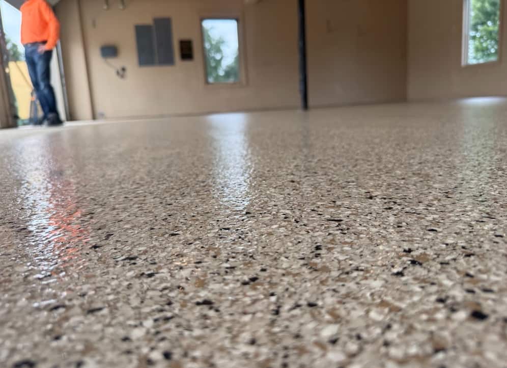 Glossy epoxy-coated garage floor with a light water sheen