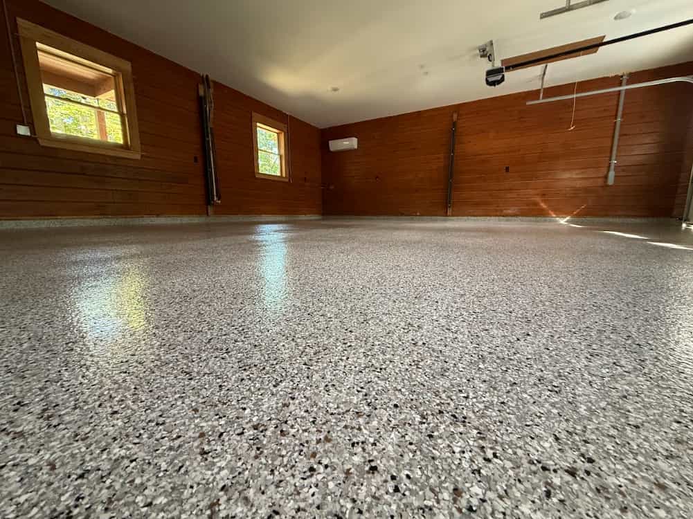 Metallic epoxy floor with swirling bronze and charcoal pigments