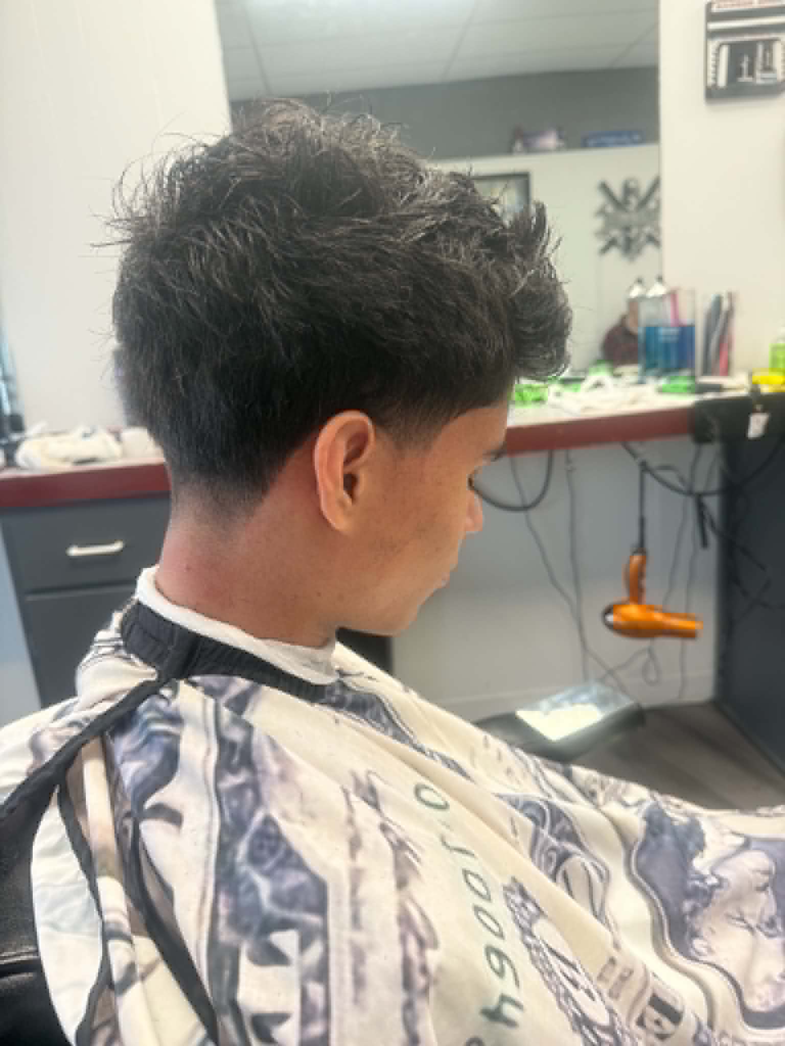 Client getting a fresh fade in the chair at Sammi Red's Real Barbers