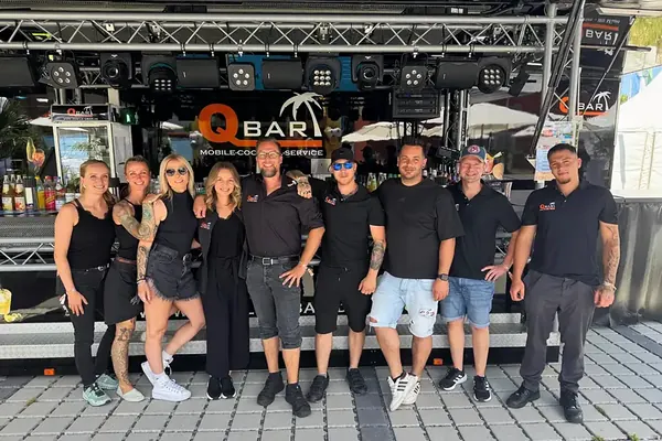 QBAR-Team vor dem Cocktailanhänger