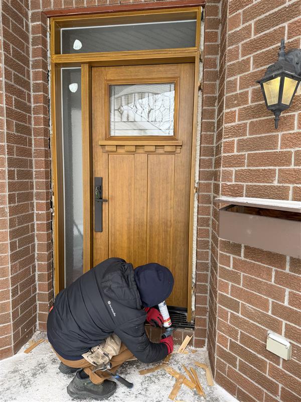 Custom doors Ottawa installation with professional installer fitting energy-efficient entry door