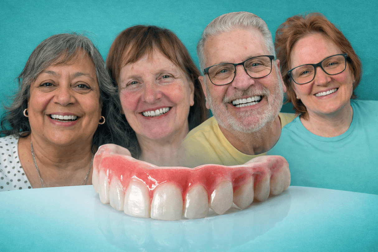 Adults smiling while learning about dental implant treatment options