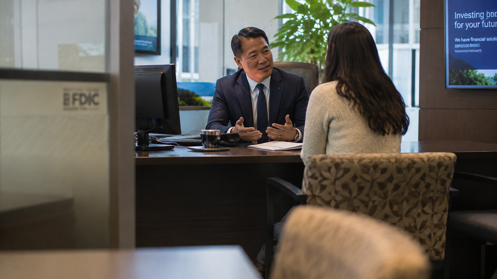 Person sitting with a banker to open an account Person sitting with a banker to open an account