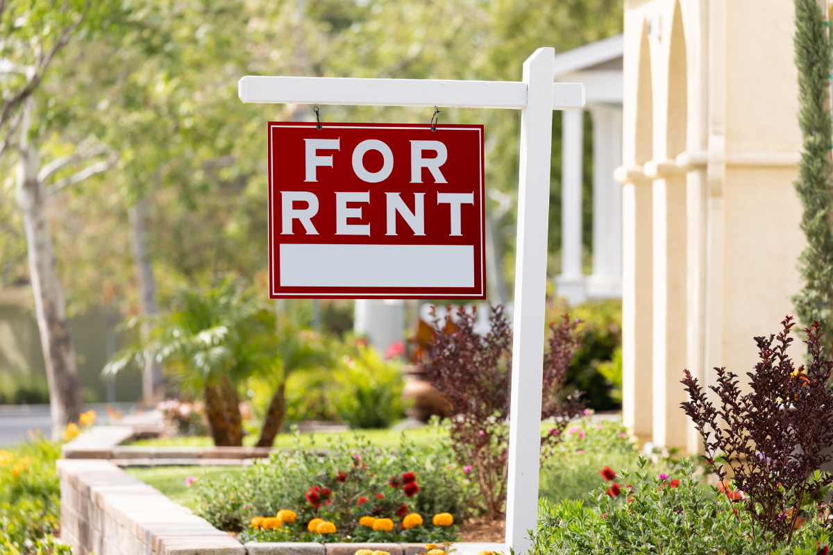 Home with a for rent sign. Home with a for rent sign.