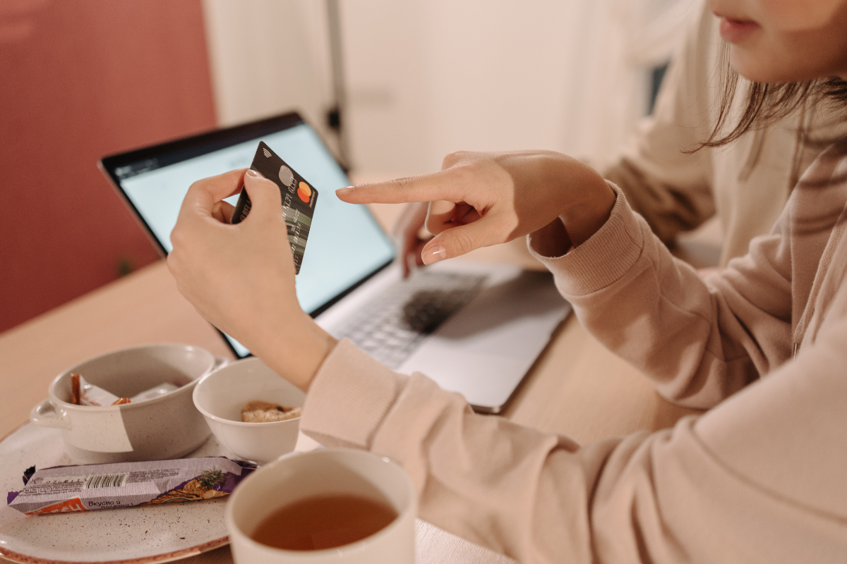 Women entering credit card on computer