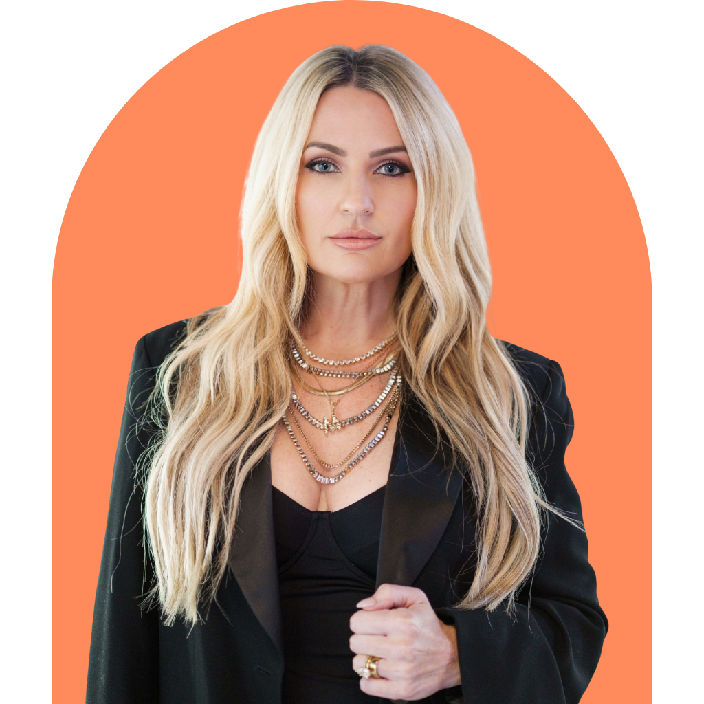 Co-host Missy Stern wearing a black blazer and gold layered necklaces, posing against an orange arched background.