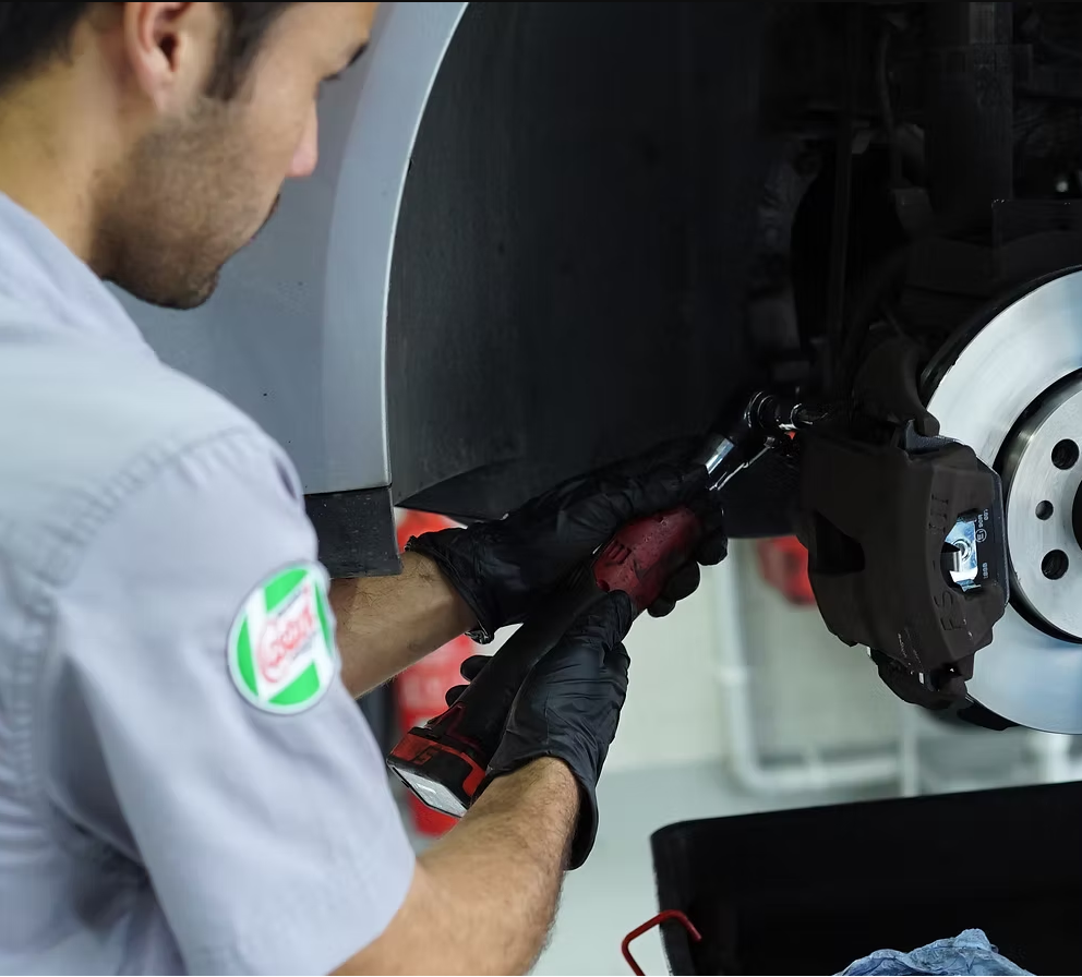 Mechanic performing brake service and inspection at 313 Automotive workshop in Russell Lea Sydney