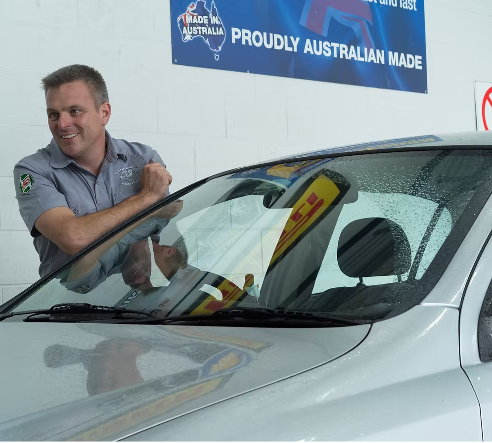 Automotive technician inspecting vehicle windscreen at 313 Automotive workshop in Russell Lea