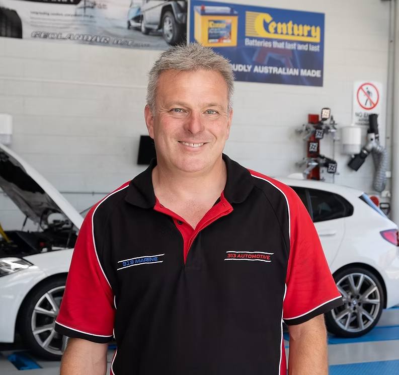 Mike Carnemolla, owner of 313 Automotive, inside the Russell Lea workshop with cars being serviced
