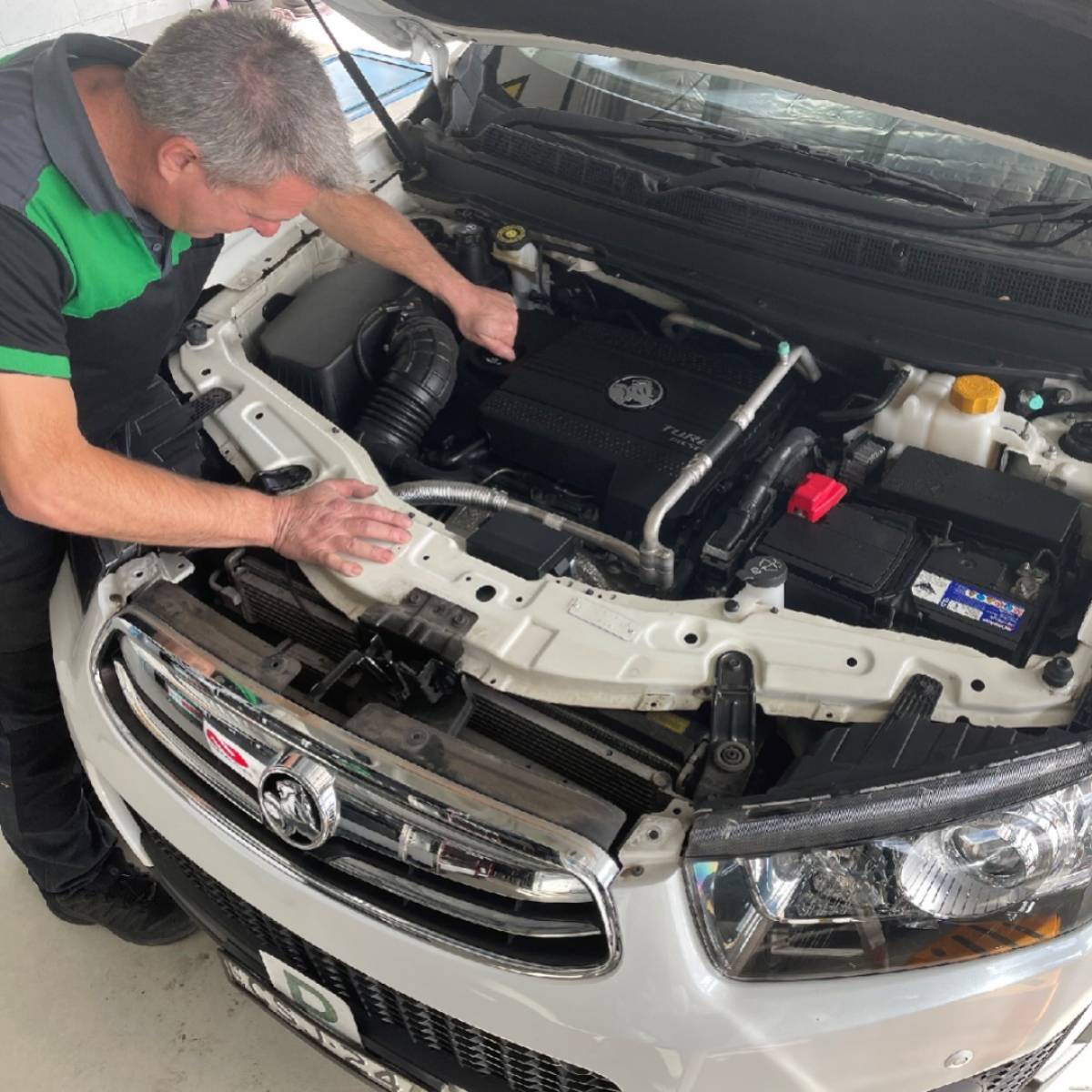 Mechanic inspecting engine during vehicle service at 313 Automotive Russell Lea