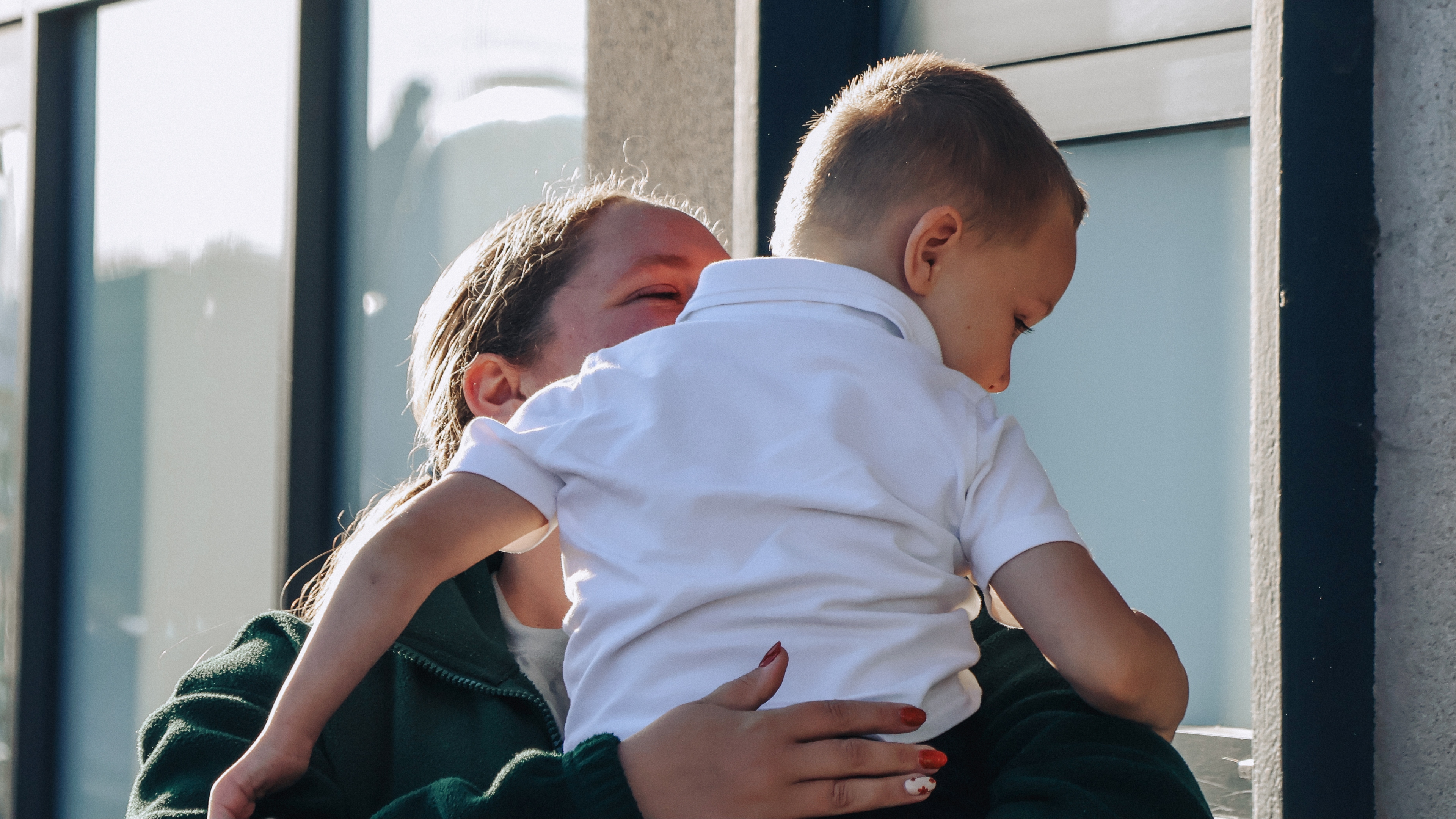 Boy in doctor's coat listens to grandfather's heart.