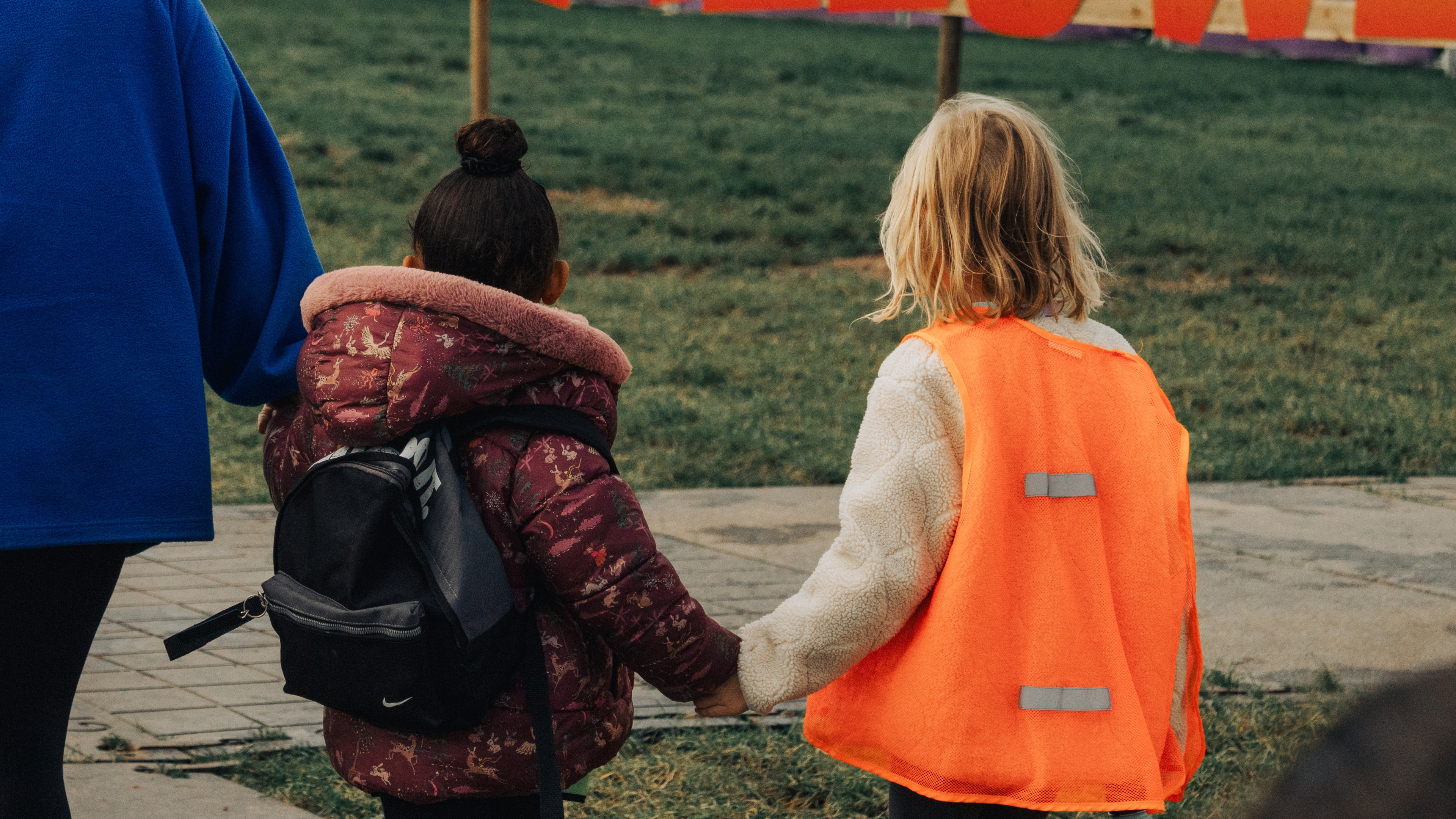 Boy in doctor's coat listens to grandfather's heart.