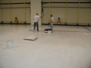 A white car in a garage with a finished floor