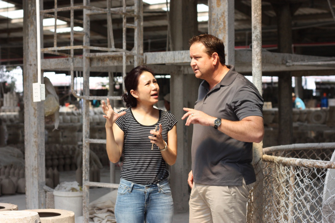 David Bishop discussing production planning with Vietnam factory team