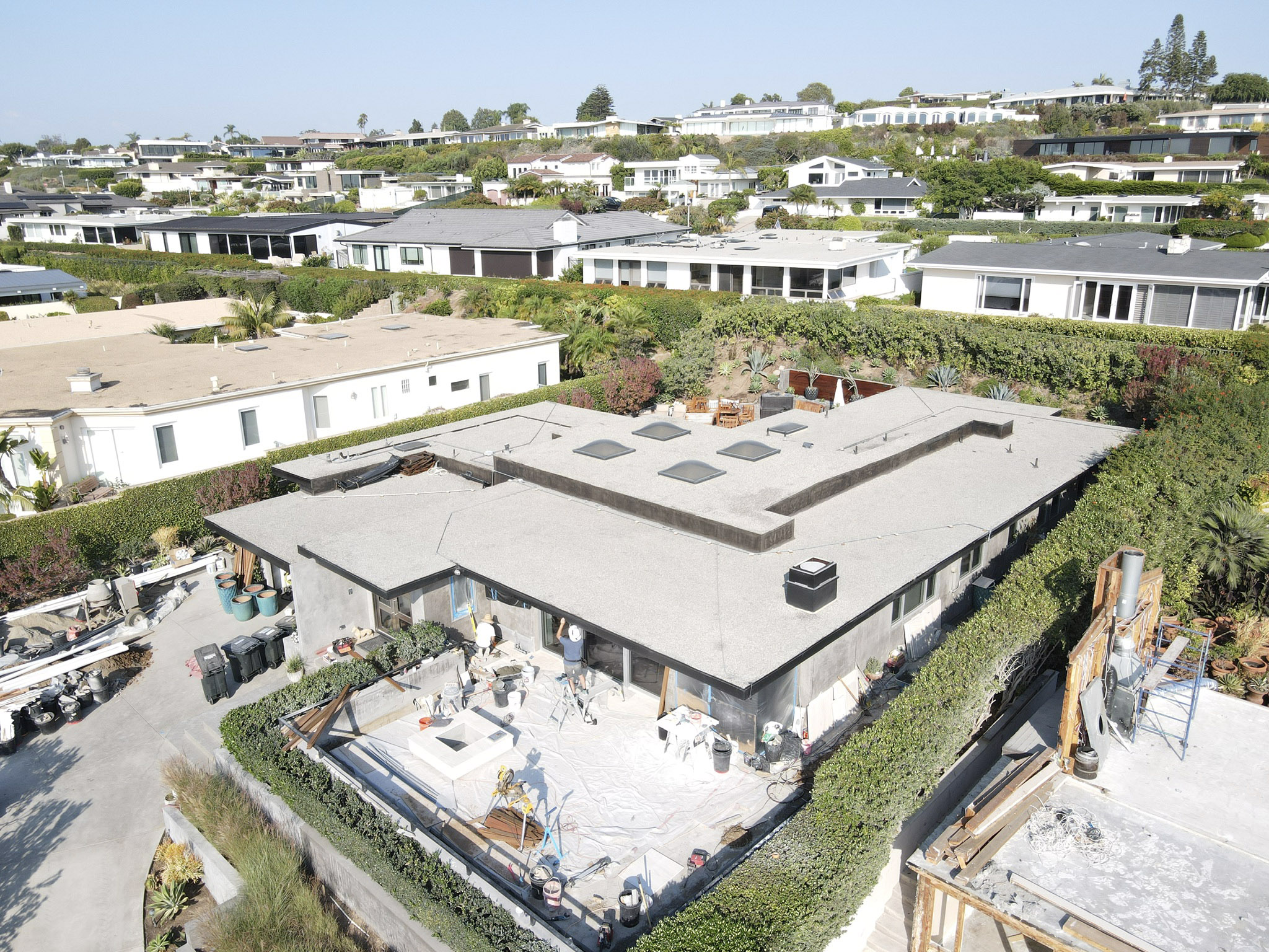 Aerial drone view of the Corona del Mar residence early in construction, before the new pool, waterway and living wall