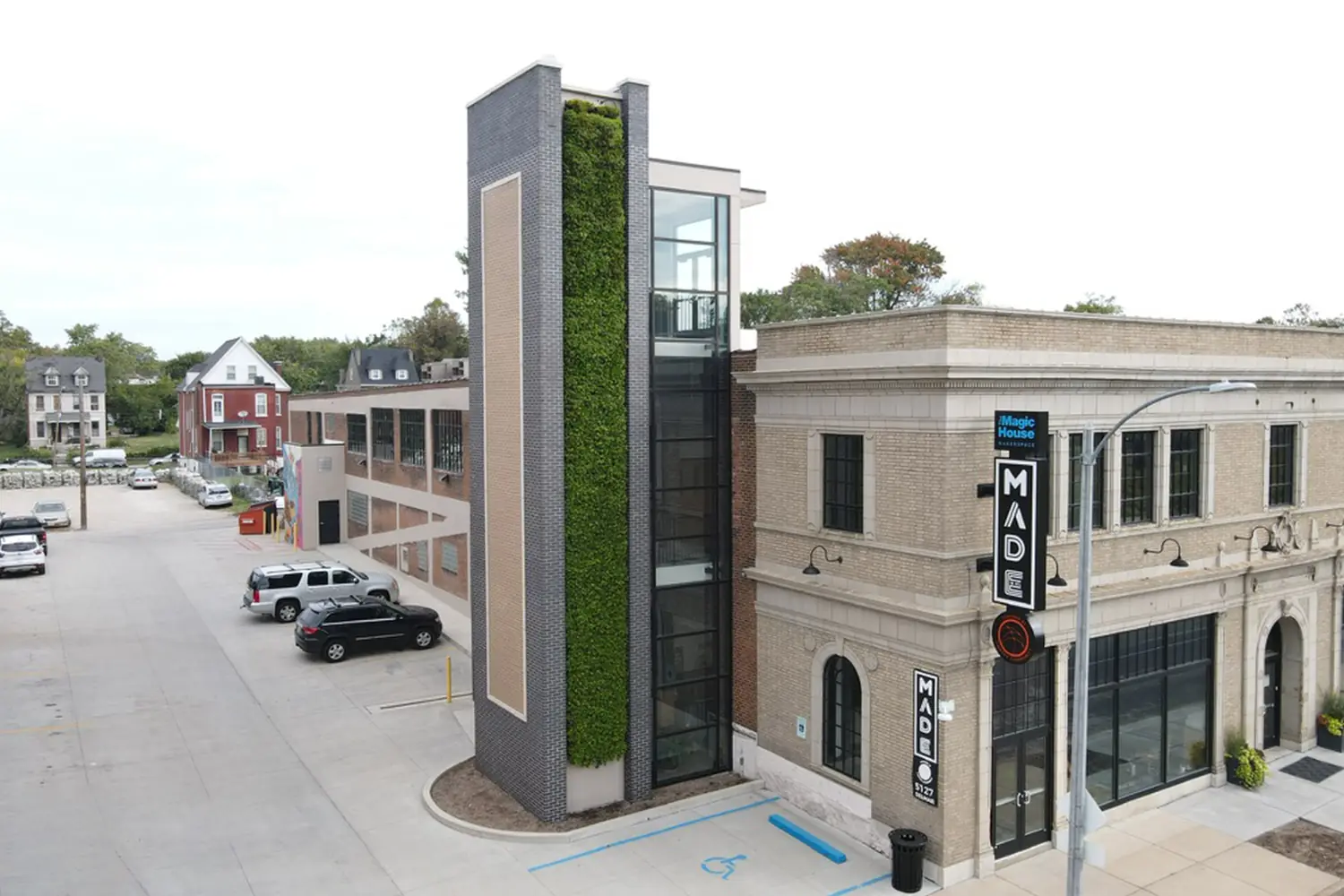 Multi-story commercial living wall tower on a corner retail building