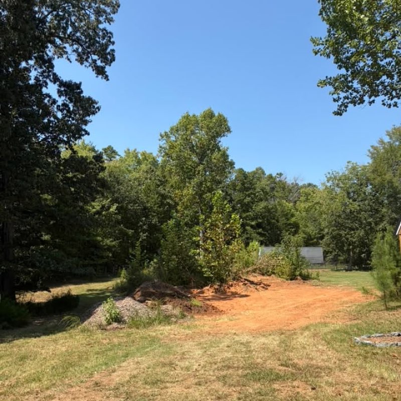 Overgrown lot in Harrisburg, NC cleared down to clean soil by Keller Lawns